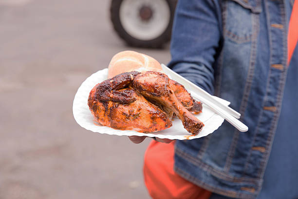 Close-up of several pieces of roasted or grilled chicken thighs with crispy, golden-brown skin, piled together