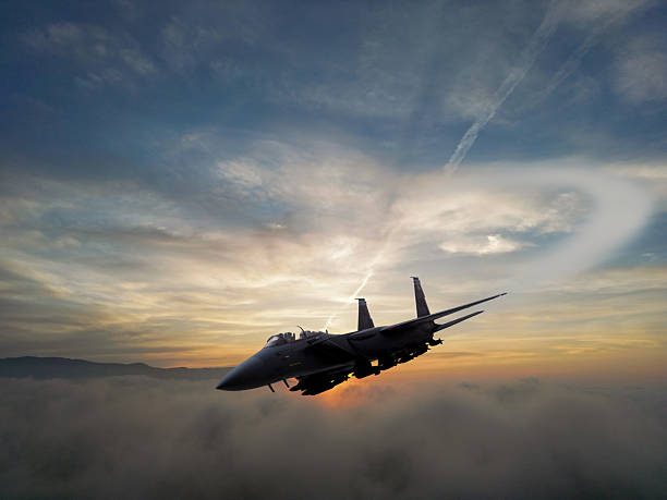 istock F-15 Fighter jet in flight over the clouds at sunset 2217701514