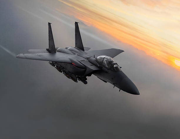istock Fighter jet in flight over the clouds at sunset 2217701526
