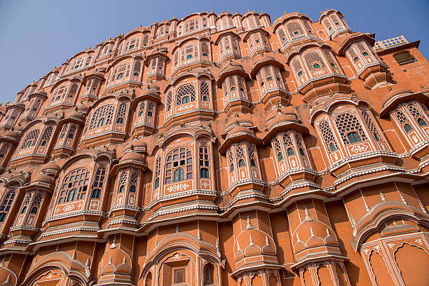 Detailed view of the ornate red and pink sandstone fa?ade of Hawa Mahal, an iconic palace in Jaipur, India known for its unique architecture and historic significance.