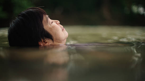 istock Woman floating in river. 2217702711