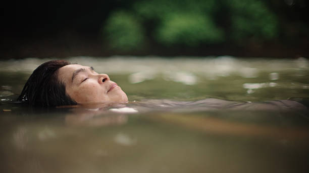 istock Woman floating in river. 2217702712