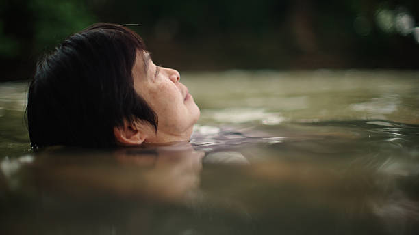 istock Woman floating in river. 2217702713