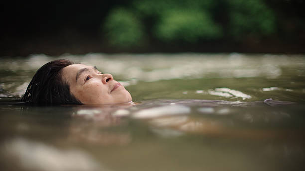 istock Woman floating in river. 2217702720