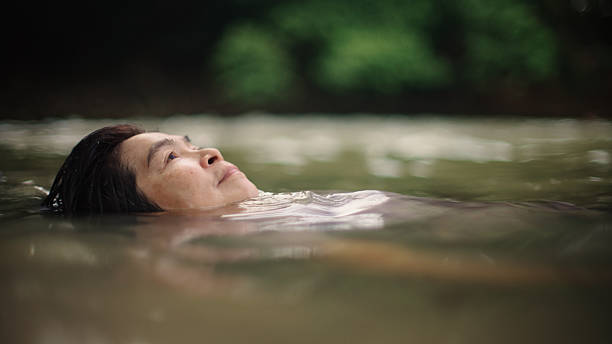istock Woman floating in river. 2217702721