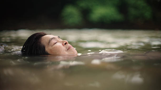 istock Woman floating in river. 2217702722