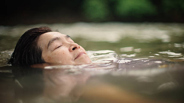 istock Woman floating in river. 2217702723