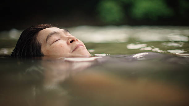 istock Woman floating in river. 2217702724