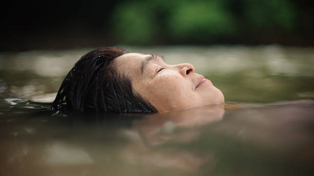 istock Woman floating in river. 2217702729