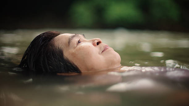 istock Woman floating in river. 2217702730