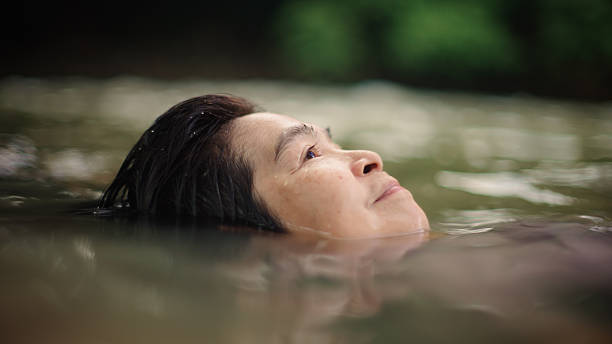 istock Woman floating in river. 2217702732
