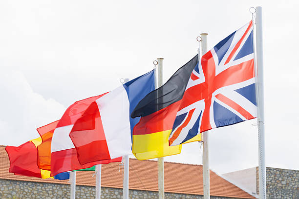 istock Flags of European nations visible against a cloudy sky in an open space 2217705374