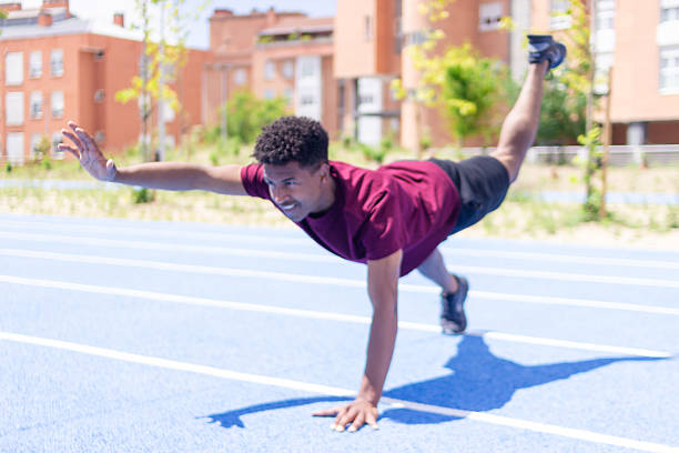 istock Young man running and training on blue athletic track 2217706244