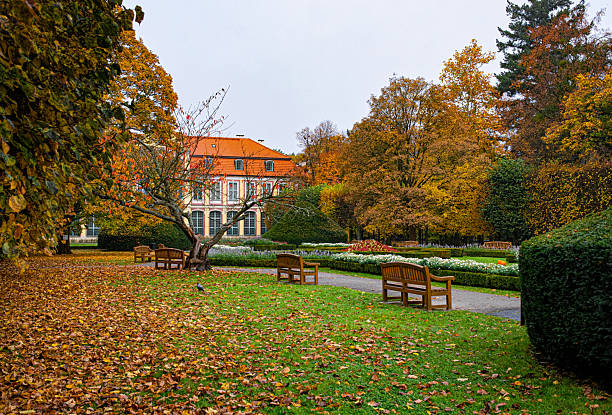 Beautiful golden autumn in the Oliwa park in Gdansk. Building of the ancient abbey  and grounds
