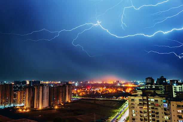 istock Dramatic Lightning Storm Over Illuminated City Skyline in Noida, India 2217708154