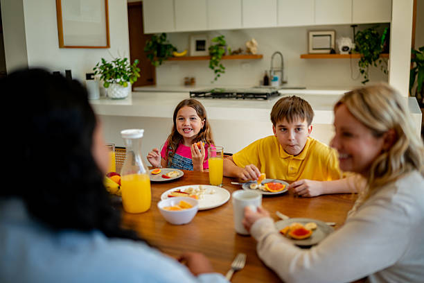 istock Child siblings talking to parentsduring breakfast at home 2217711398