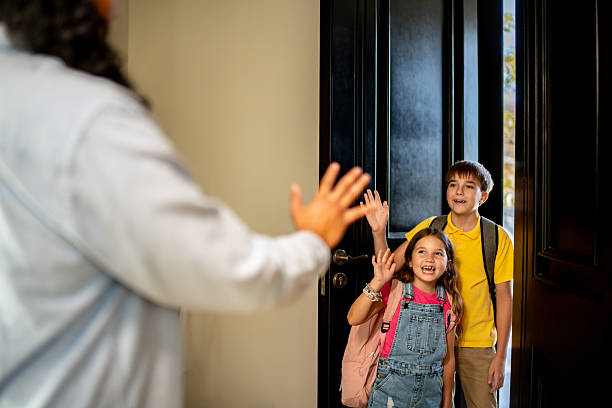 istock Child siblings saying good bye to father and going to school 2217711596