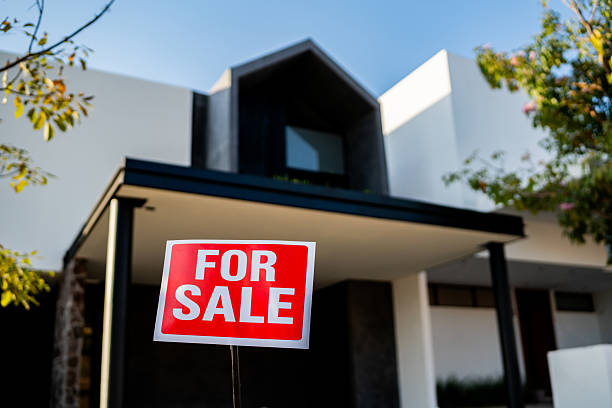 istock House with for sale sign in front yard 2217712370