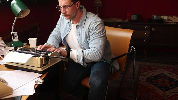 istock Young author thinking intensely in vintage office, cinematic soft-focus 2217713065