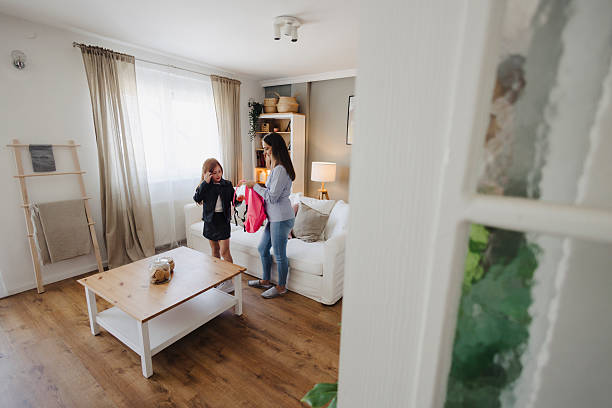 istock Mother Helping Her Cute Daughter Get Ready for School 2217713705