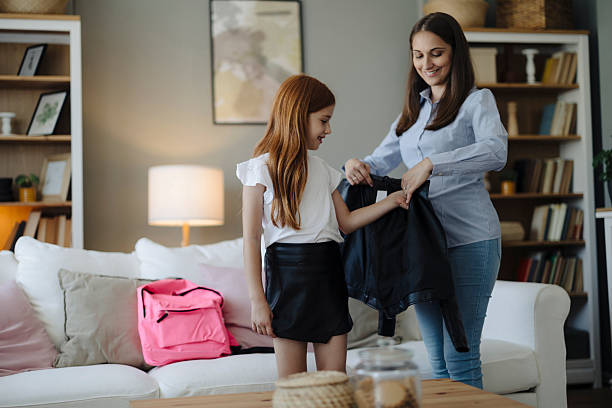 istock Mother Helping Her Cute Daughter Get Ready for School 2217713720
