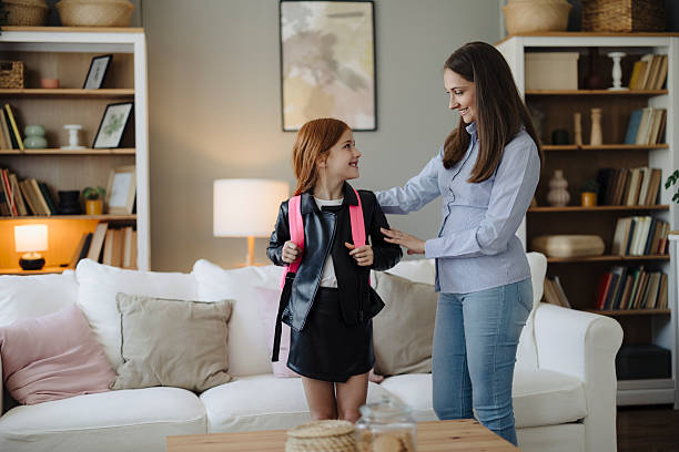 istock Mother Helping Her Cute Daughter Get Ready for School 2217713799