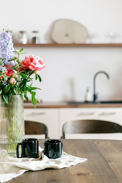 istock Boho style living room with flowers and coffee cups in modern home setting 2217713886