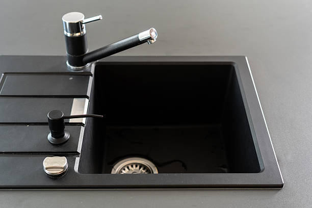 istock Modern black kitchen sink with stylish faucet on sleek countertop 2217713896