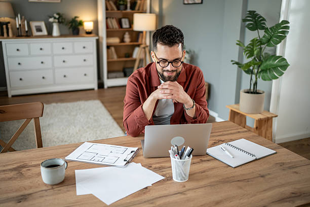istock Architect working from home having a video call on his laptop 2217715674