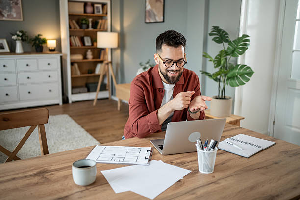 istock Architect working from home having a video call on his laptop 2217715675
