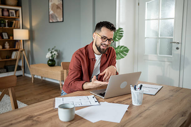 istock Architect working from home having a video call on his laptop 2217715676