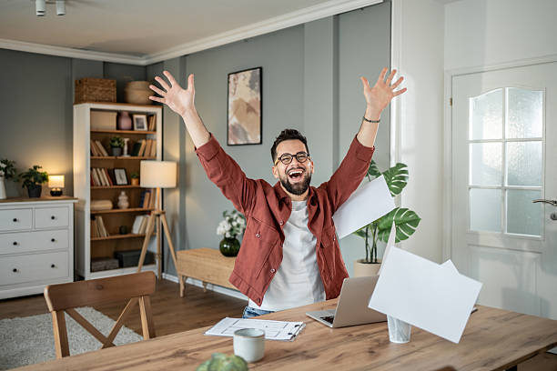istock Excited freelancer celebrating success at home office 2217715764