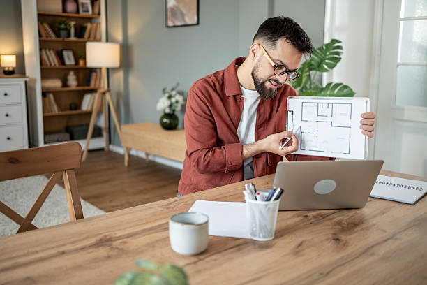 istock Architect showing blueprint during online meeting from home office 2217715776