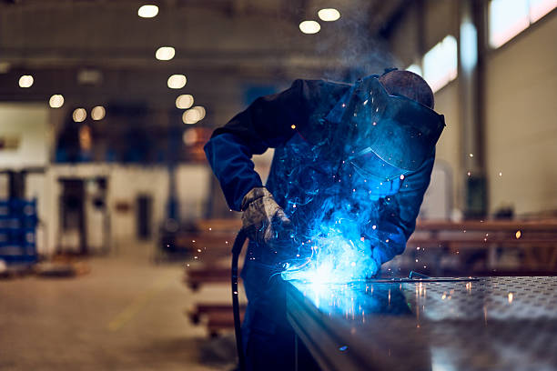 istock Industrial Welder Working with Bright Sparks in a Factory Setting 2217717101