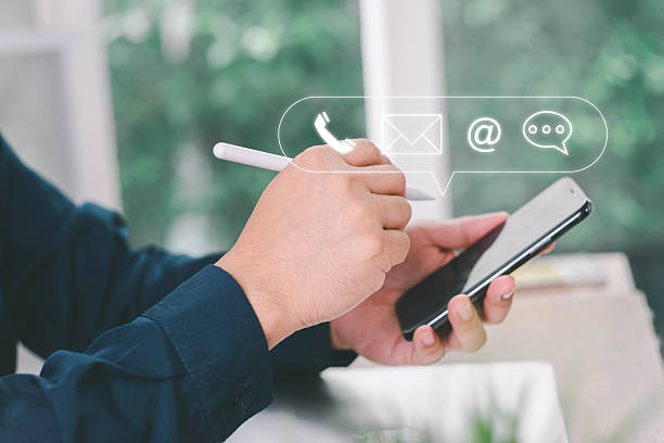 istock Concept of contact us, customer support, service, icon, Contact us or Customer support hotline people connect. Businessman using a laptop with the (email, call phone, mail) icons. customer service. 2217719636