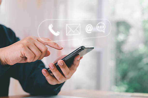 istock Concept of contact us, customer support, service, icon, Contact us or Customer support hotline people connect. Businessman using a laptop with the (email, call phone, mail) icons. customer service. 2217719637