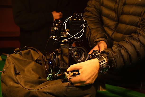 istock Setting up a camera on top of a tripod to keep it stable so that it can shoot smooth footage even on a moving car 2217722331