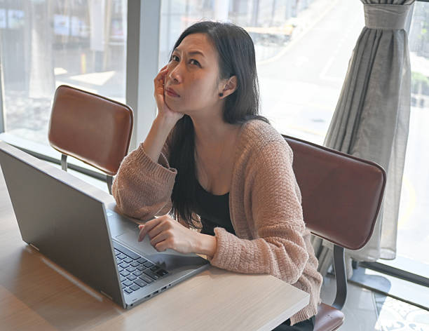 istock Asian business women using notebook and serious and headache for working 2217724421