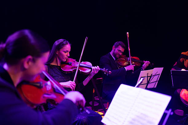 istock String quartet concert. Two violins, viola and violoncello. Talented musicians play instruments, creating graceful art on stage 2217726398