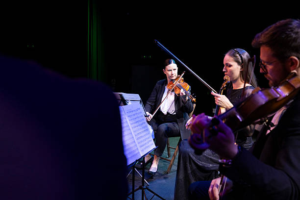 istock A concert of a string quartet performing compositions on stage in front of an audience 2217726414