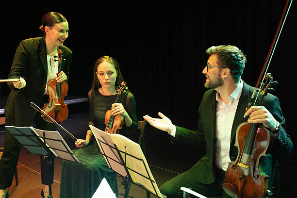 istock Three musicians are making final arrangements and preparations before a performance of classical music on the theater stage 2217726417