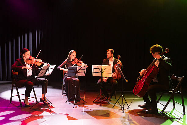 istock Talented musicians play instruments, making eye contact and creating graceful art on stage 2217726446