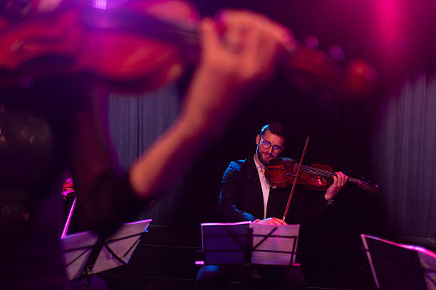 istock Focused musician playing the viola during a classical music concert 2217726450