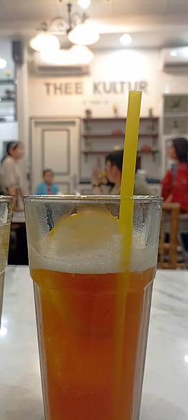 istock ice tea with yellow straw 2217729611