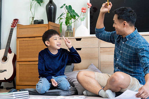 istock Back to School and Interactive Learning. A father and son engage in fun educational activities at home. 2217735172