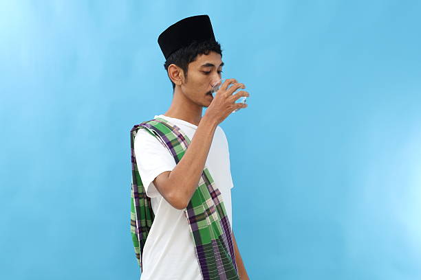 istock Asian muslim man drinking for break fasting. Ramadan concept 2217737733