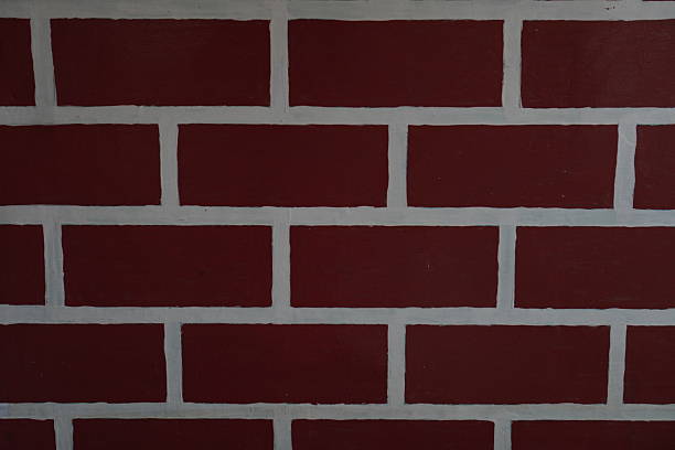 Close-up of a brick wall under construction resting on a thermal insulation panel, showing the process of building a new house with energy-efficient materials