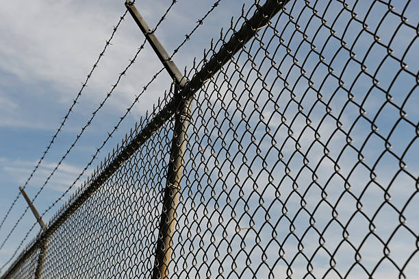 istock iron chain link fence and blue sky 2217742729