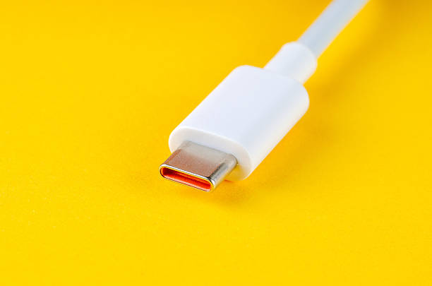 istock White USB Type-C cable on bright yellow background, macro close-up 2217747716