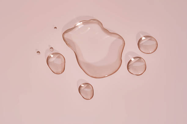 istock The texture of micellar water on a pink background. 2217747852